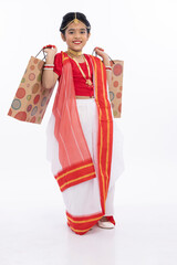 Bengali girl in traditional clothing  and holding shooping bag
