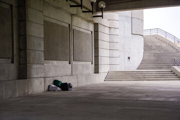 Homeless person's belongings under a bridge
