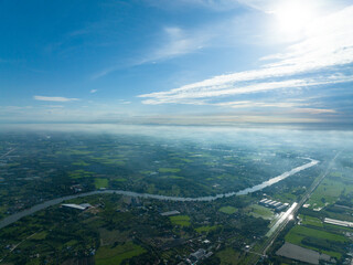 flying with bluesky day time with approching mist in horizon and river curve on bottom