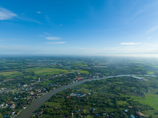 Fototapeta na wymiar flying with bluesky day time with approching mist in horizon and river curve on bottom
