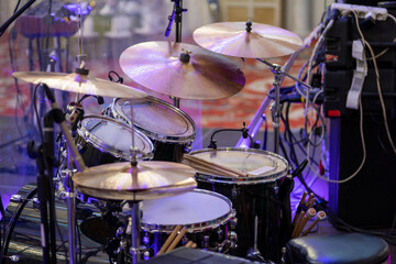 Fototapeta na wymiar Professional musical instrument. Drum set with drum cymbals. Drum sticks are on the drum.
