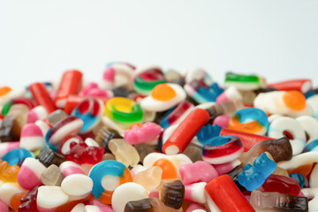 Tasty mix of jelly colorful candies isolated on a white background.
