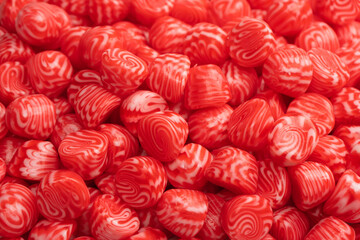 Red round tasty gummy candies as a background.