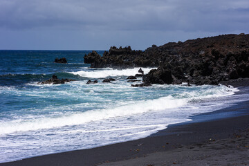 Fototapeta na wymiar Ocean waves crashing on hardened black lava.Lanzarote, Canary Islands, Spain
