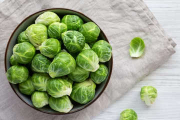 Foto op Aluminium Raw Organic Brussel Sprouts in a Bowl, top view. Flat lay, overhead, from above. © Liudmyla