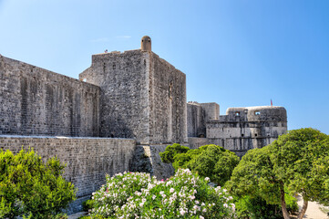 Fototapeta na wymiar Medieval architecture in the walled city and the rugged coastline of Dubrovnik, Croatia with views of the Adriatic Sea