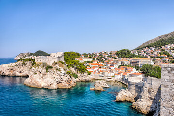Naklejka na ściany i meble Medieval architecture in the walled city and the rugged coastline of Dubrovnik, Croatia with views of the Adriatic Sea