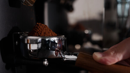 closeup grinding coffee in portafilter