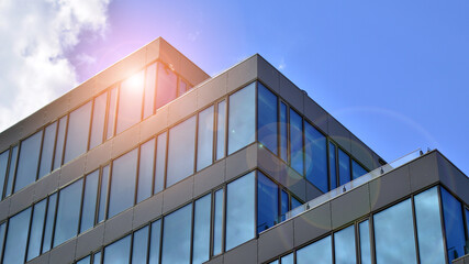 Architecture details. Modern glass building facade in sunny day. Business background.