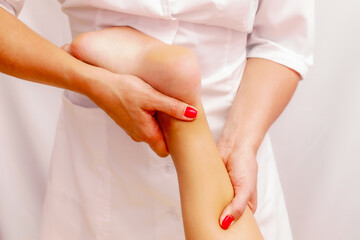 Young woman getting a massage at the spa. Body care. Therapeutic foot massage in the spa salon. Skin care, well-being