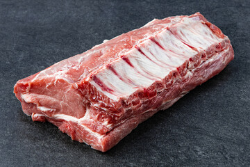 Pork ribs. Raw meat on a gray stne background