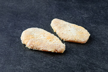 Frozen chicken Cutlet on stone Background. Frozen Semi-finished Products