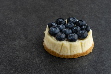 Blueberry cheesecake on stone background