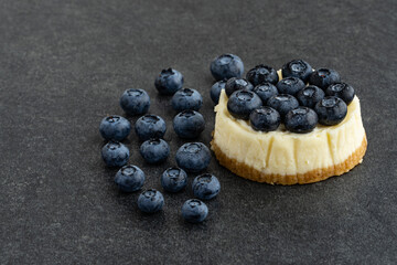 Blueberry cheesecake on stone background