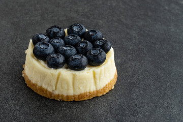 Blueberry cheesecake on stone background
