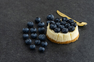 Blueberry cheesecake on stone background