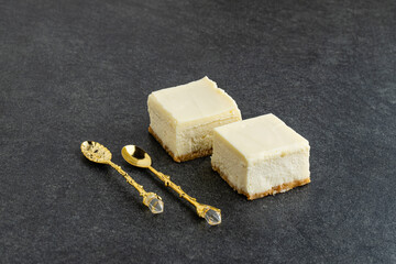 Slice of plain New York Cheesecake on stone table
