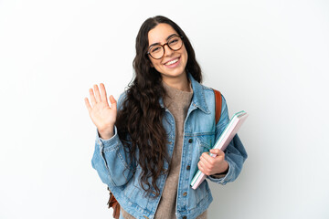 Young student woman isolated on white background saluting with hand with happy expression