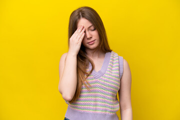 Young caucasian woman isolated on yellow background with headache