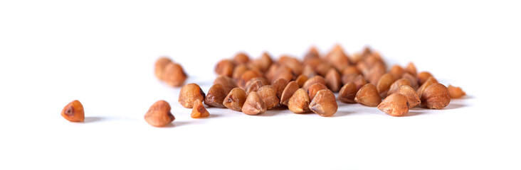 Pile of buckwheat seeds isolated on white background, closeup