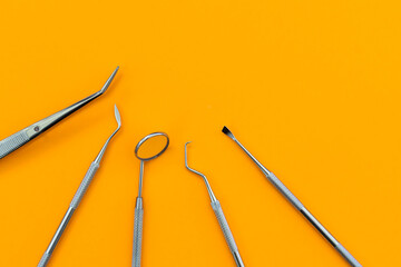 Professional Dentist tools in dental office: dentist mirror, forceps curved, explorer curved,...