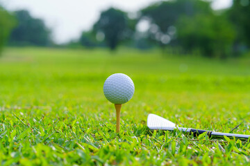 Golf ball on green grass ready to be struck on golf course