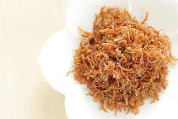 Japanese, pepper and small sardine fishes on white dish