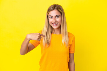 Blonde Uruguayan girl isolated on yellow background with surprise facial expression
