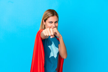 Blonde woman over isolated background in superhero costume and fighting © luismolinero