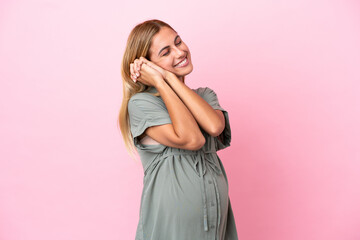 Fototapeta premium Young Uruguayan woman isolated on blue background pregnant and happy