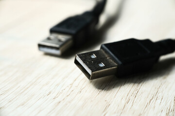 Macro shot of USB cable on wooden table. Modern technology concept. Selective focus