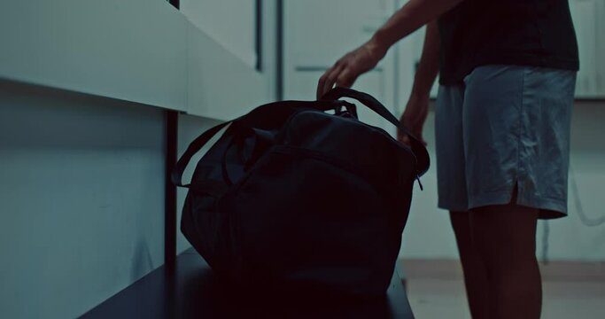 black sportsman in locker room in gym, dark-skinned guy is openning sports bag, 4K, Prores