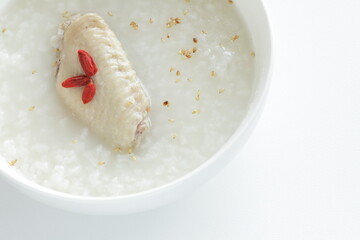 Chinese food, chicken wings and dried wolf berries in rice porridge 