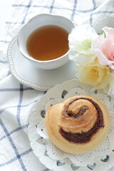 Cinnamon bun on white dish for breakfast image