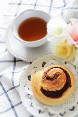 Cinnamon bun on white dish for breakfast image