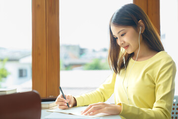 Education and literacy concept, College student girl use phone to listening lecture and taking note