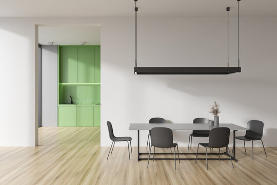 Light kitchen interior with eating table and seats, shelves and appliances