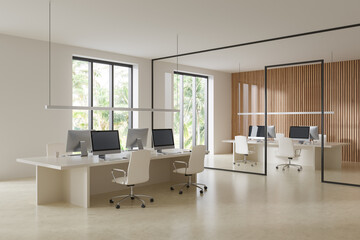 Office interior with coworking zone and pc computers, panoramic window