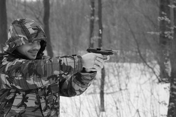 Fototapeta premium Man shooting with a pistol in the forest