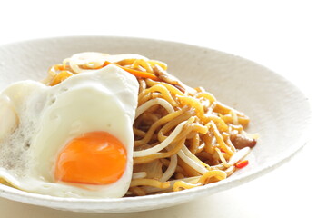 Chinese food, carrot and soy sprout with pork fried noodles served with sunny side up fried egg
