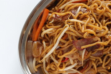 Chinese food, pork and soy sprout fried noodles on stainless steel plate
