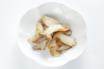 Pan fried Japanese  oyster mushroom slices on plate with copy space