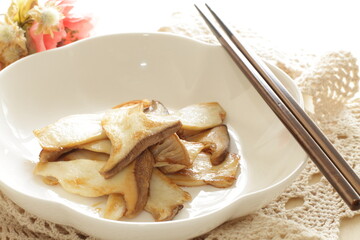 Pan fried Japanese  oyster mushroom slices on plate with copy space