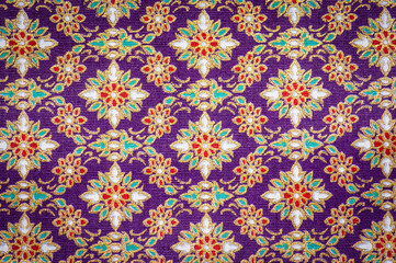 Closeup flower on batik sarong pattern background in Thailand - obrazy, fototapety, plakaty