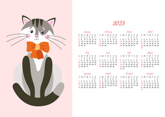 Children's wall calendar for 2023 with a funny cat with a bow on a pale pink background. The week starts on Sunday.