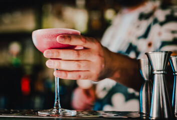man hand bartender making sweet and sour refreshing cocktail on the bar counter