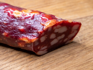 Smoked sausage on a wooden cutting board, food close-up shot. Tasty sausage.