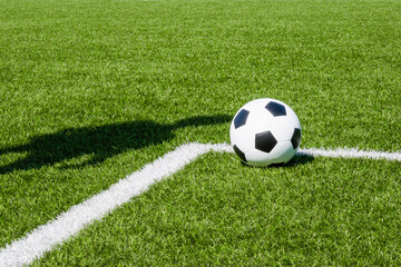 Soccer football sport background. Soccer ball and shadow of player on artificial turf soccer field...