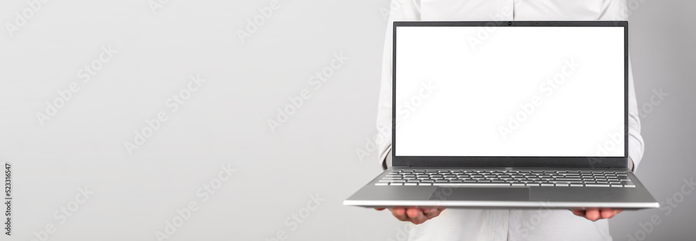 Poster Banner with hands holding laptop mockup with white screen. Person using computer for showing presentation at work. Copy space