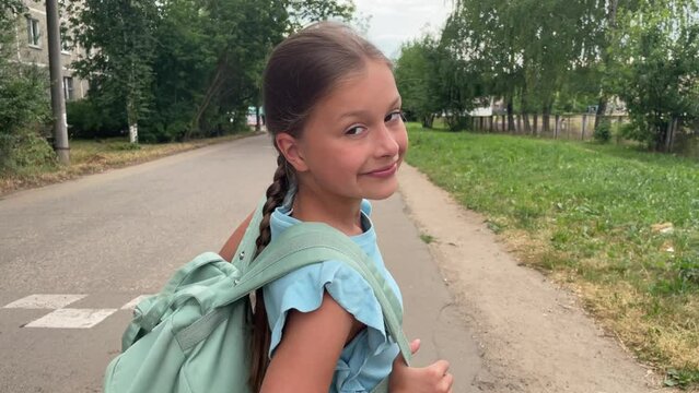Portrait of a girl looking at the camera, caucasian girl going to school after vacation, back to schoo